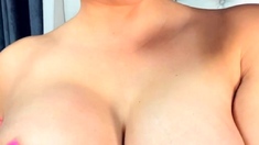 Hot babe with big boobs playing with her lactating boobs