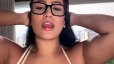Busty babe playing with her big boobs